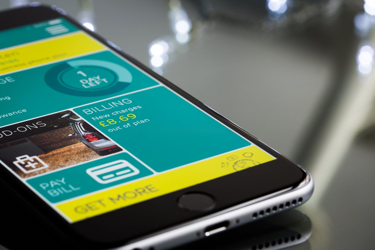 gallery-6 Close-up of a smartphone displaying a billing app interface on a reflective surface.